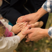 Close up of a family holding hands
