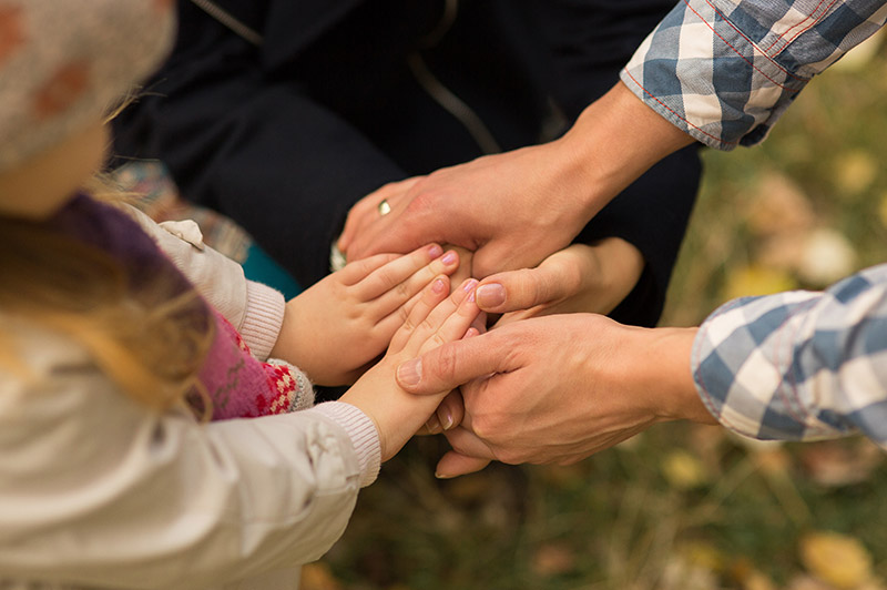 Close up of a family holding hands