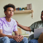 Teenage boy receiving support from an adult