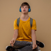 Teenager meditating wearing headphones