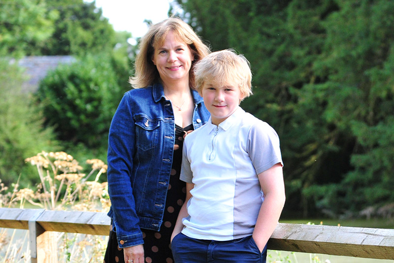 A boy and his mum with trees in the background