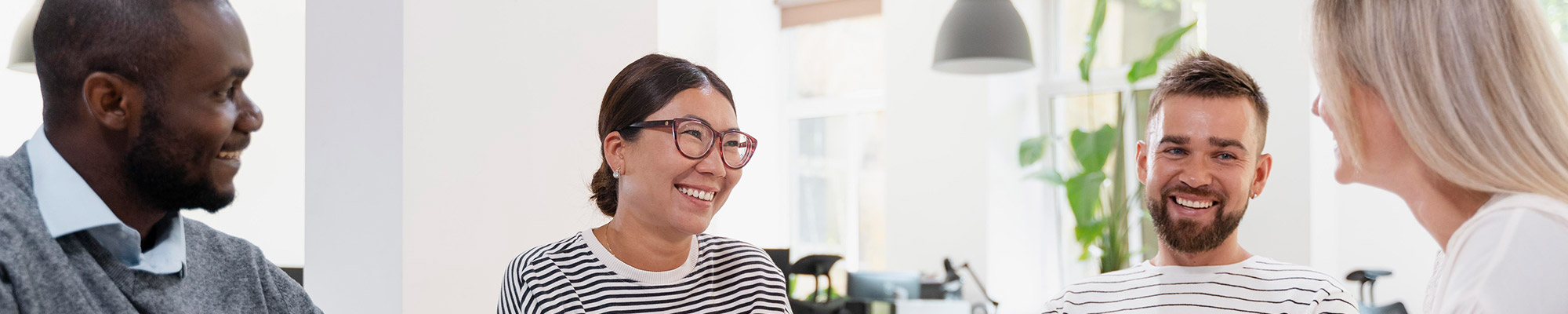 People smiling during an office meeting