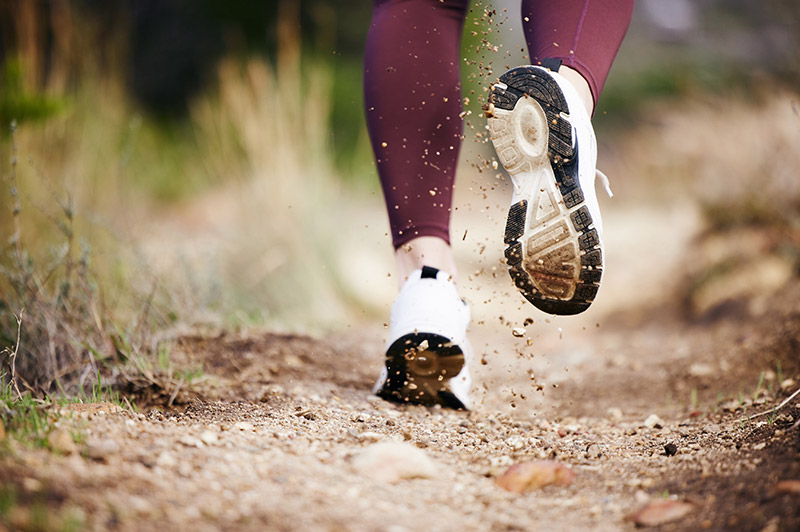 Close up of someone running along a track