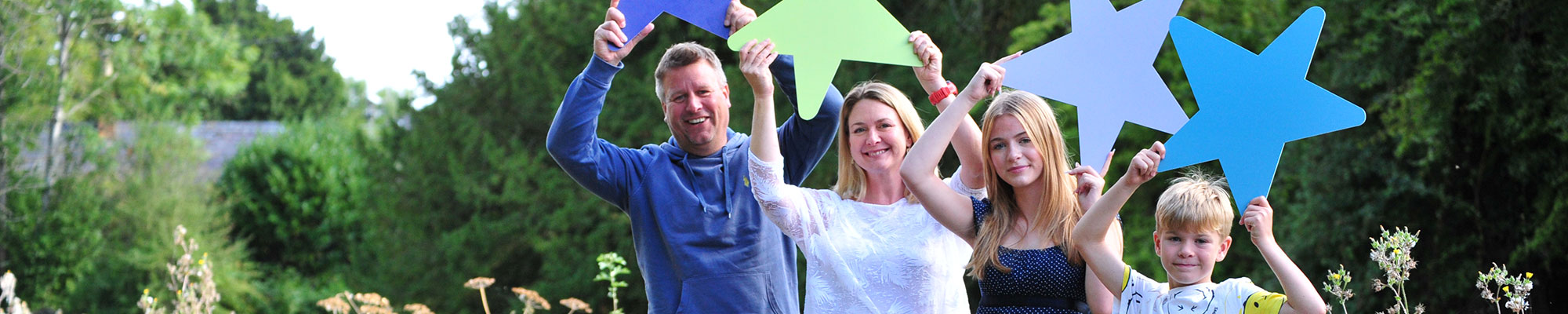 Family holding up SeeSaw stars