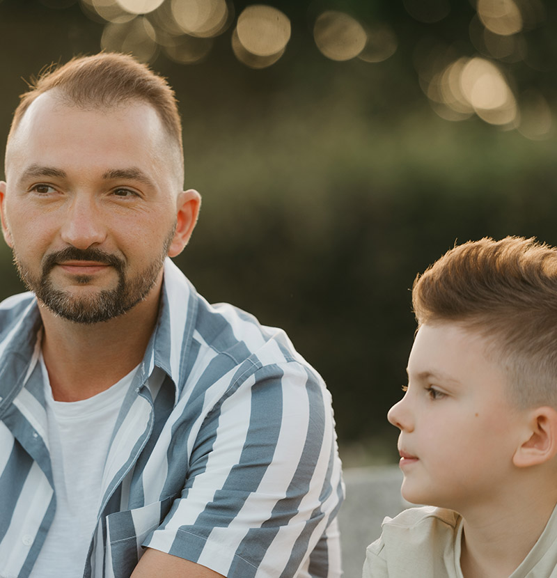 Dad sat with his son outside