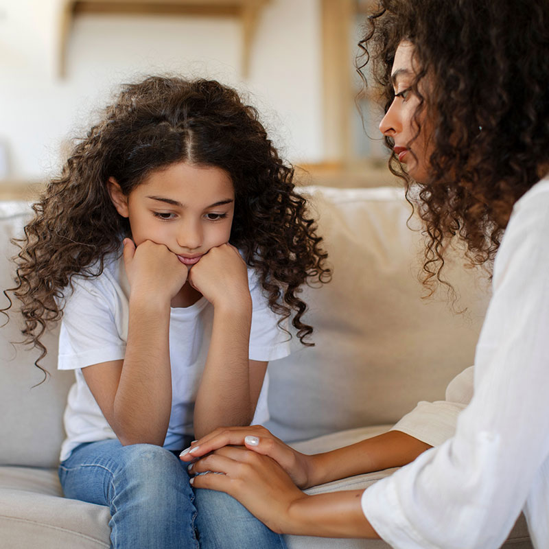 Girl being comforted by her mum