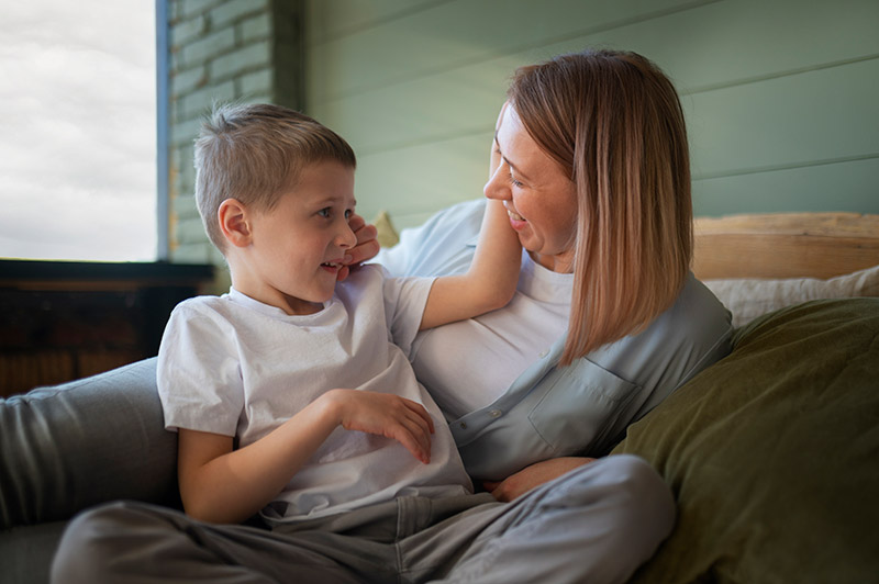 Young boy smiling with mother