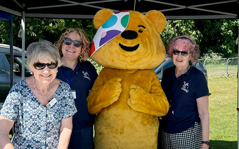 SeeSaw staff members with Pudsey Bear